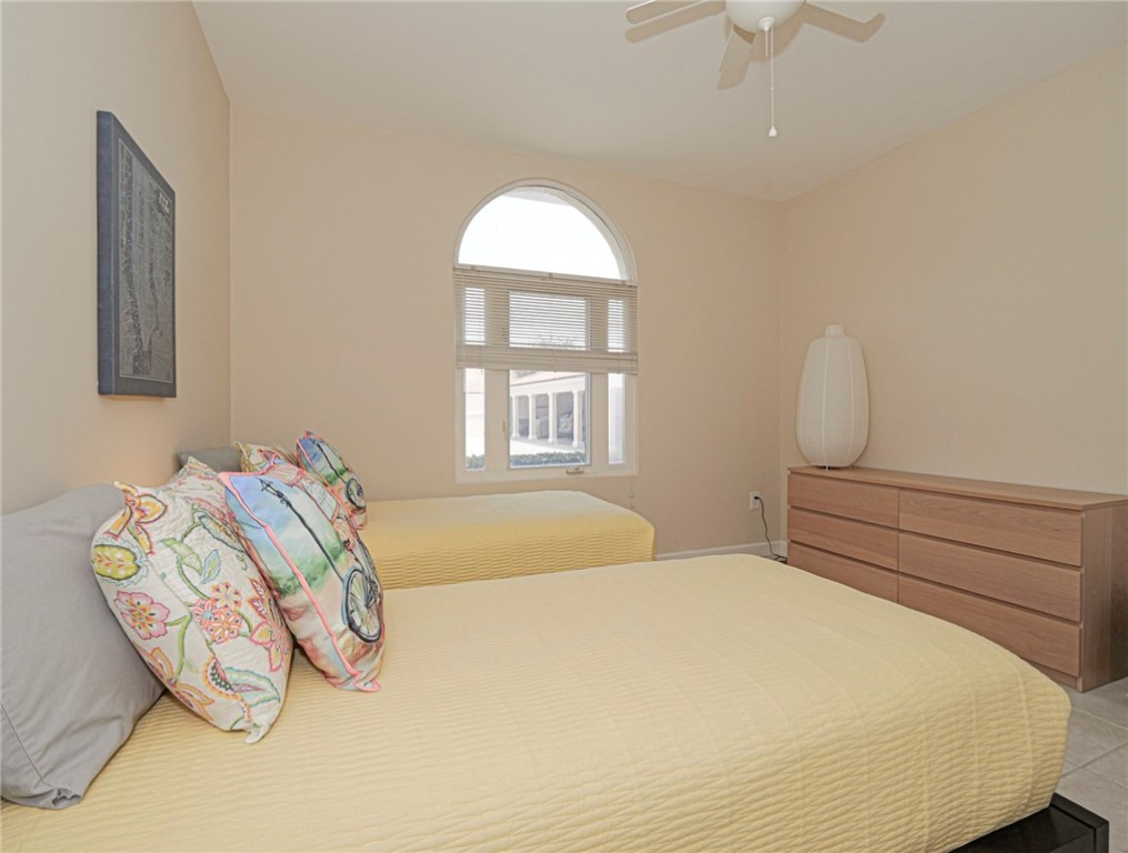 5035 Harmony Circle, Unit 101 Vero Beach, FL 32967 - Photo 23 of 36 a bedroom with a bed and window