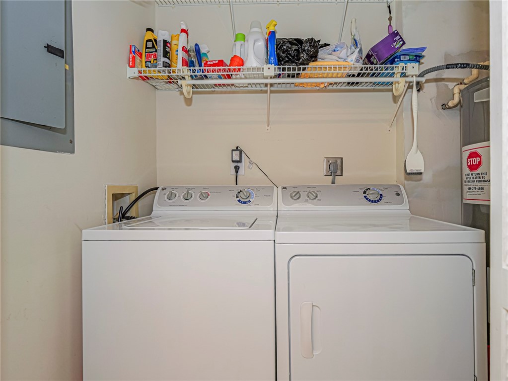 5035 Harmony Circle, Unit 101 Vero Beach, FL 32967 - Photo 25 of 36 a utility room with dryer and washer
