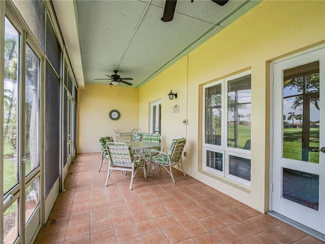 a dining room with furniture water view and a floor to ceiling window