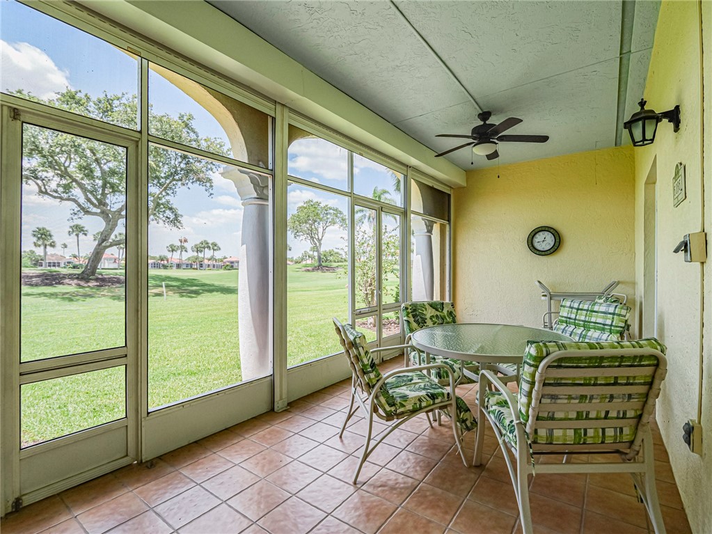 5035 Harmony Circle, Unit 101 Vero Beach, FL 32967 - Photo 28 of 36 a view of an outdoor dining space with furniture