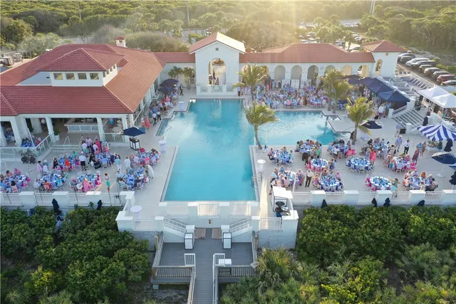 a view of swimming pool with outdoor seating and plants