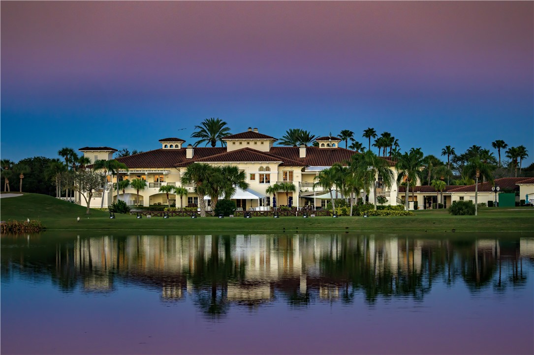 5035 Harmony Circle, Unit 101 Vero Beach, FL 32967 - Photo 34 of 36 a view of a lake with houses in front of it