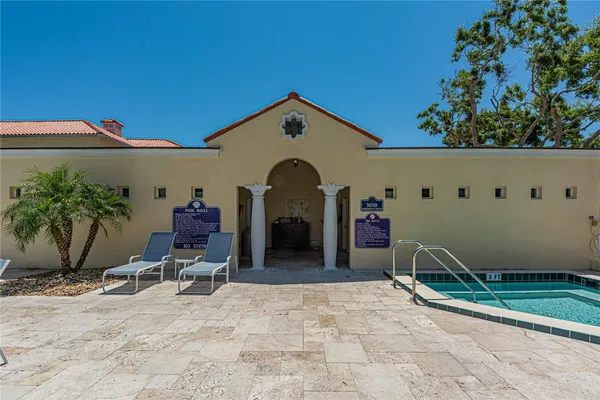 a view of a livingroom with a chair and potted plants