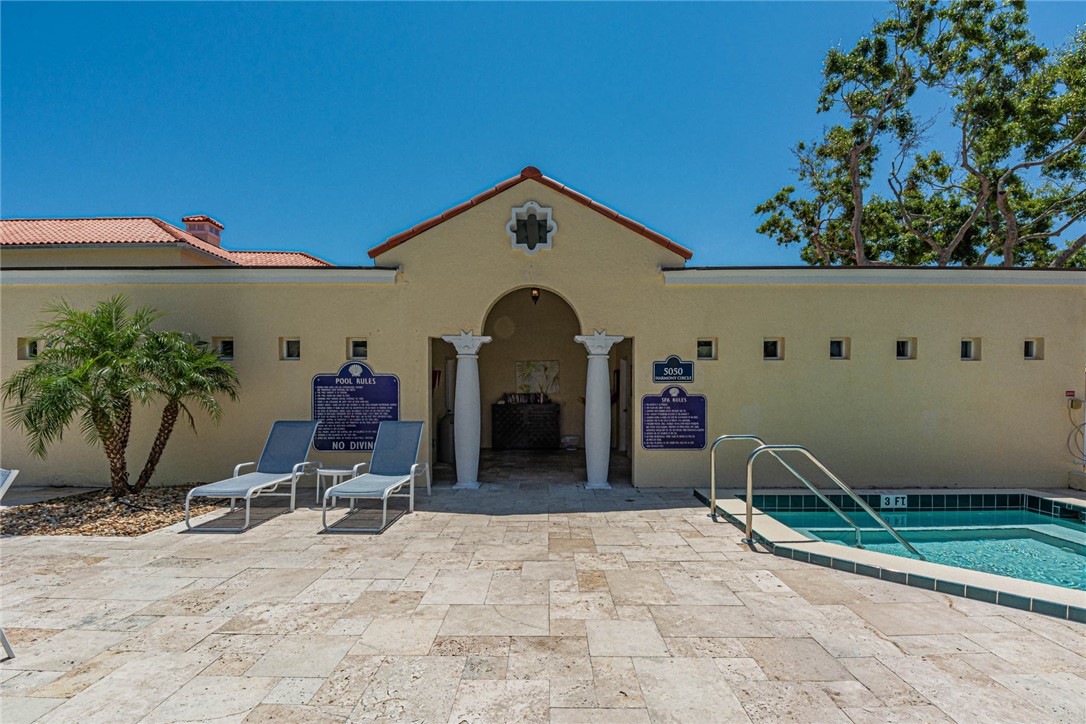 5035 Harmony Circle, Unit 101 Vero Beach, FL 32967 - Photo 4 of 36 a view of a livingroom with a chair and potted plants
