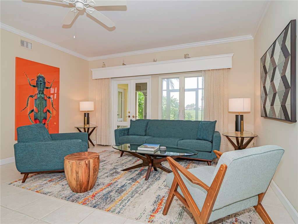 5035 Harmony Circle, Unit 101 Vero Beach, FL 32967 - Photo 6 of 36 a living room with furniture and a window