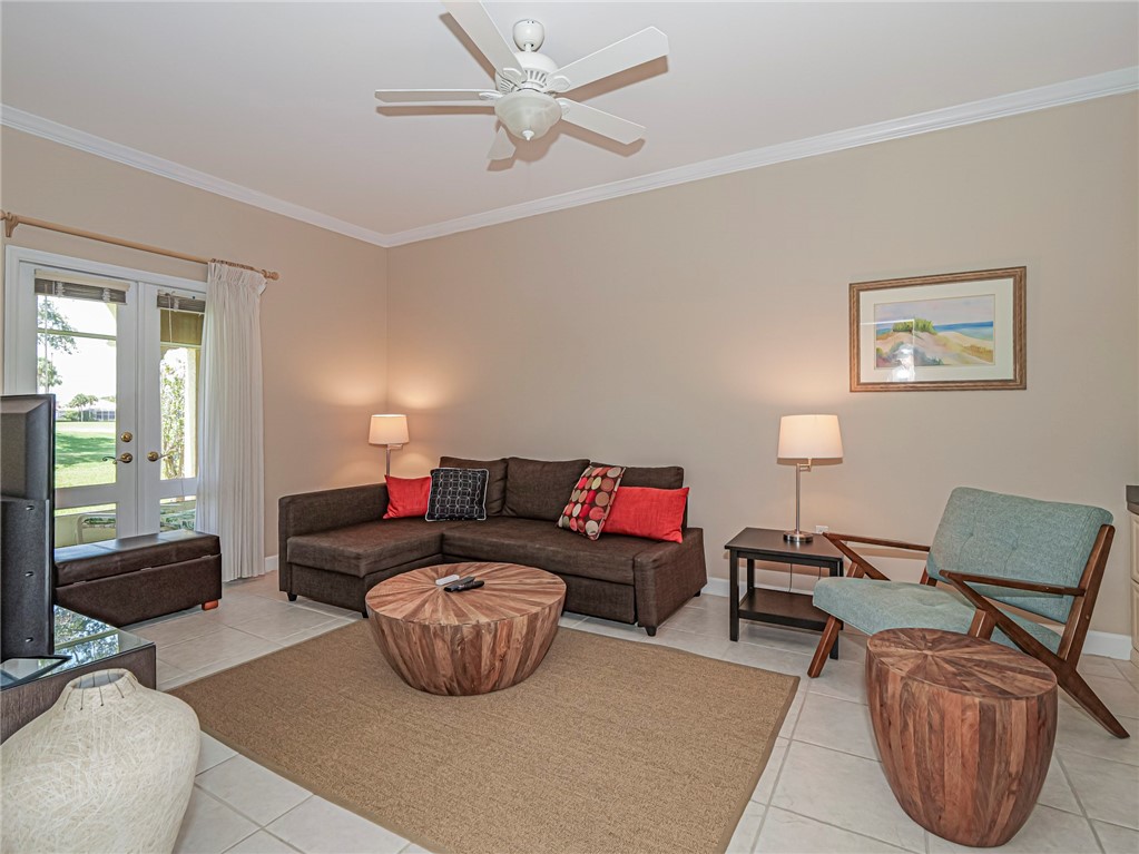 5035 Harmony Circle, Unit 101 Vero Beach, FL 32967 - Photo 9 of 36 a living room with furniture and a window