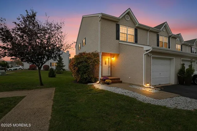 a view of a front of a house with a yard