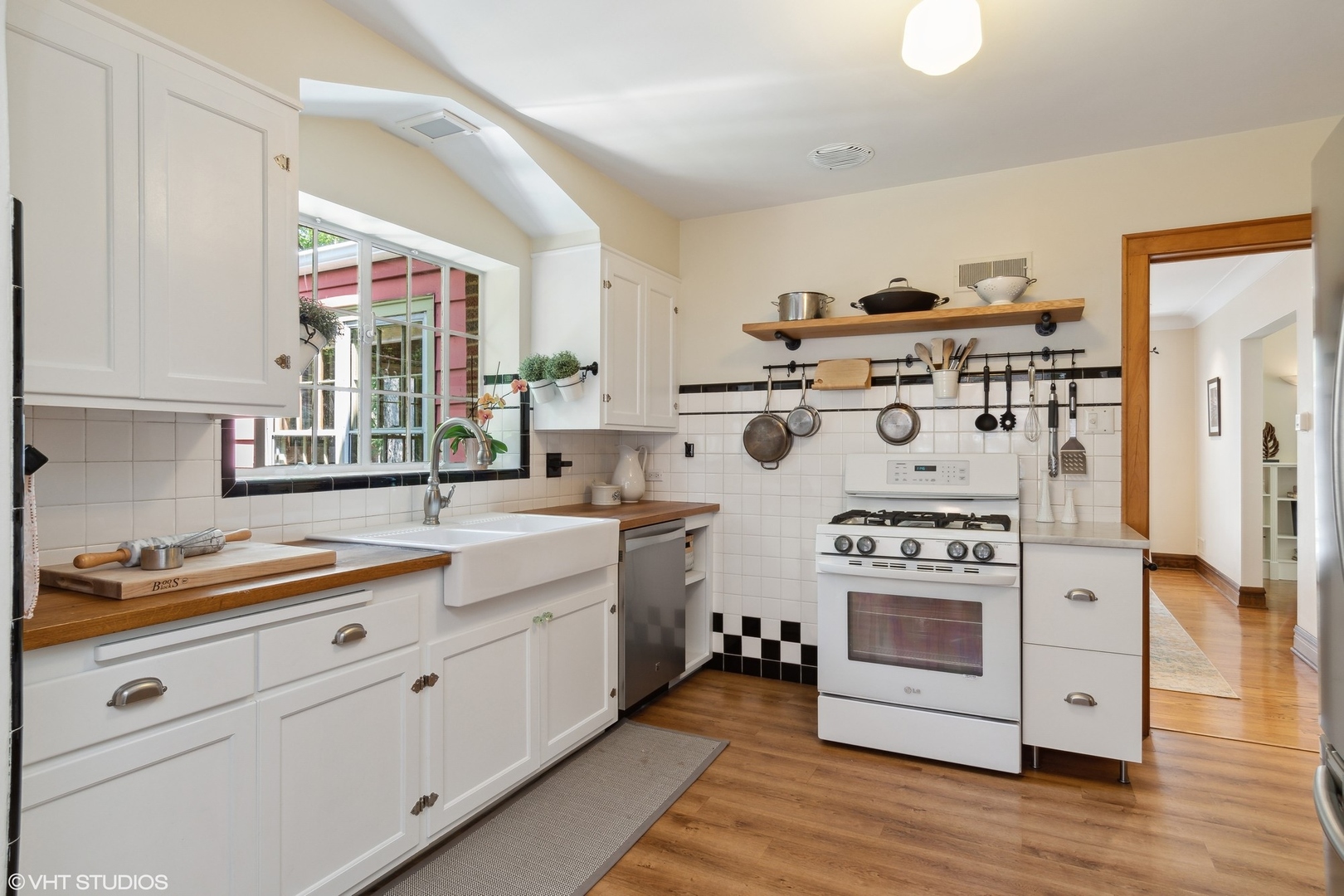 414 Audubon Road Riverside, IL 60546 - Photo 13 of 51 a kitchen with cabinets a stove and wooden floor