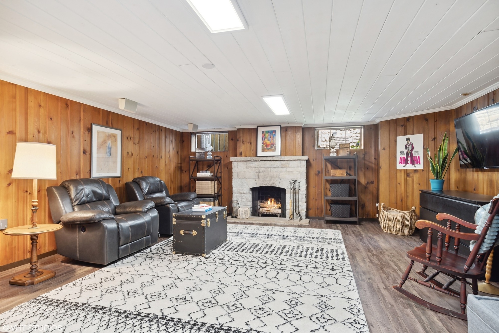 414 Audubon Road Riverside, IL 60546 - Photo 31 of 51 a living room with furniture a rug a fireplace and a flat screen tv