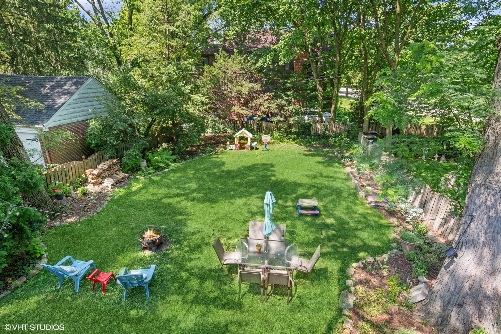 414 Audubon Road Riverside, IL 60546 - Photo 39 of 51 a backyard of a house with table and chairs plants and large trees