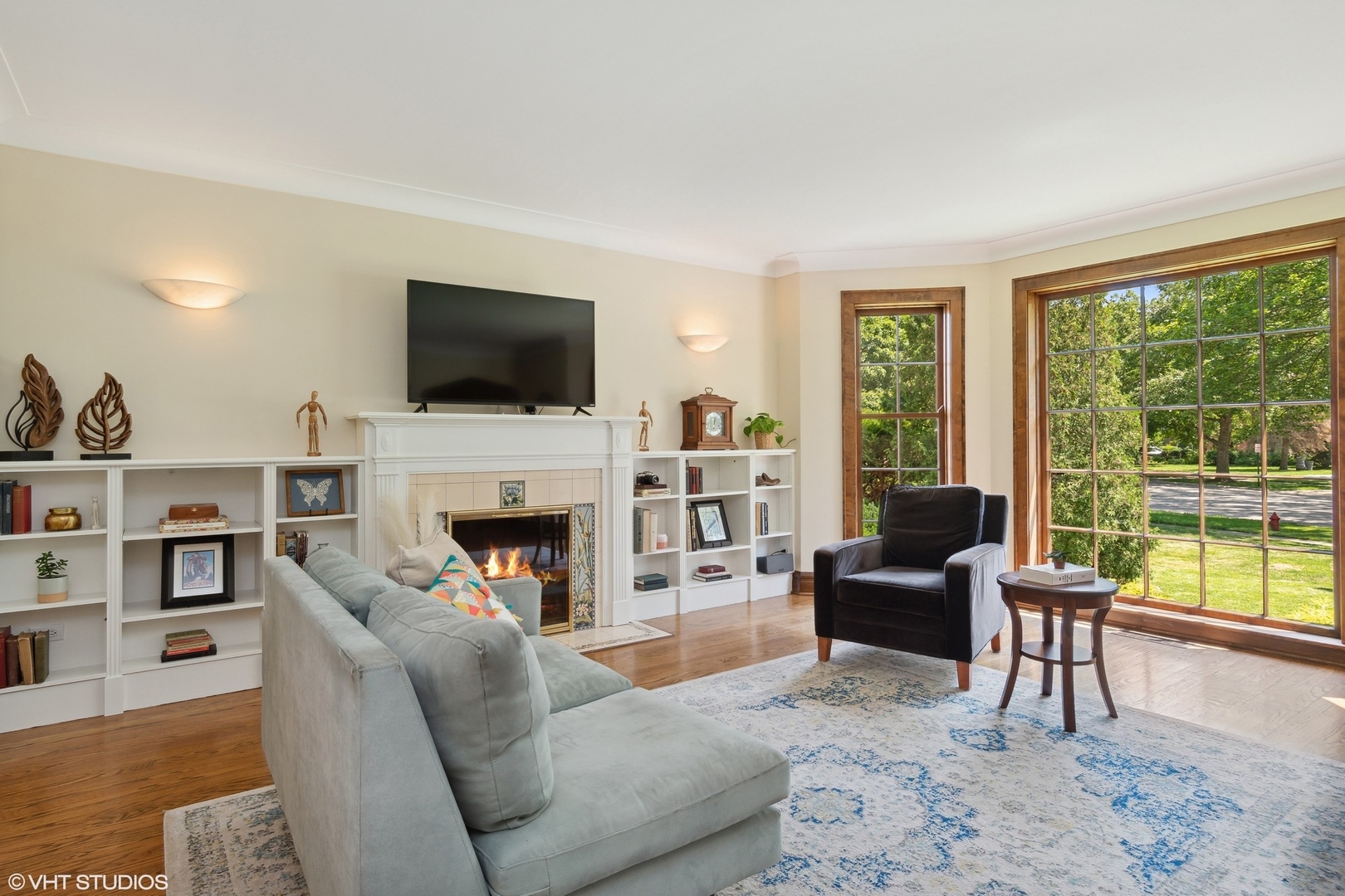 414 Audubon Road Riverside, IL 60546 - Photo 10 of 51 a living room with furniture a fireplace and a flat screen tv