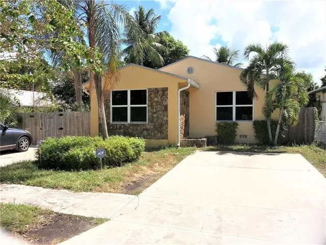 a front view of house with yard and trees