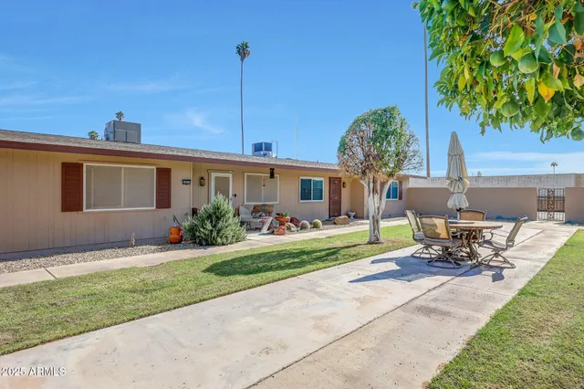 a front view of a house with a garden and patio