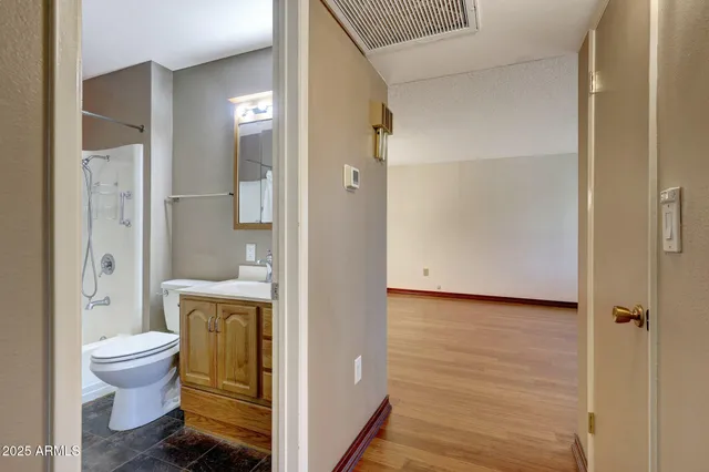 a bathroom with a toilet and a shower