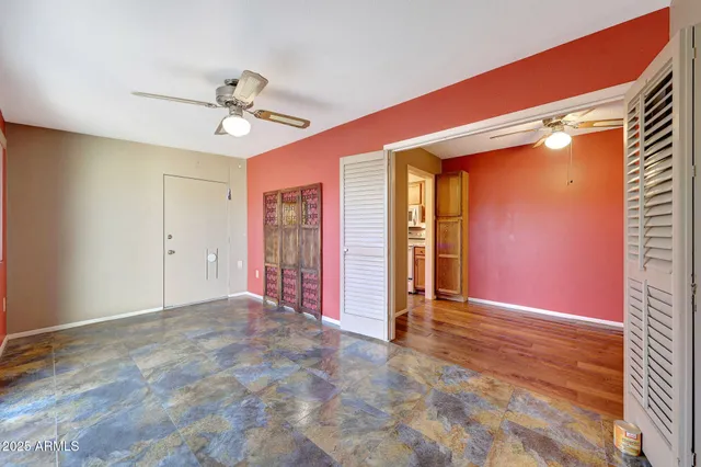 a view of a livingroom with a ceiling fan and window
