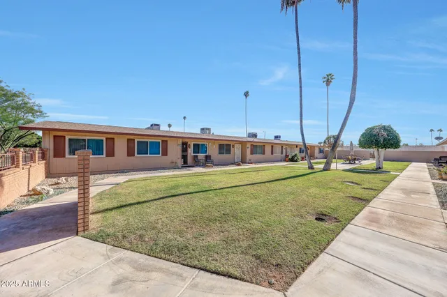 a front view of a house with a garden and plants