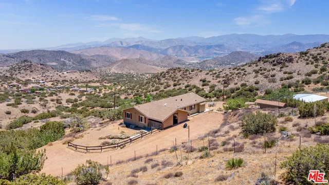 an aerial view of residential house and sandy dunes