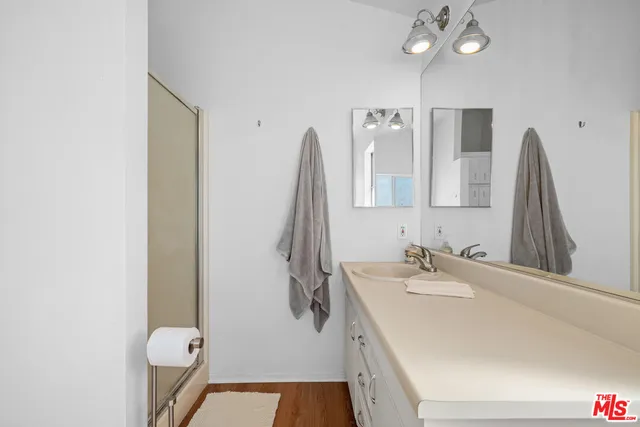 a bathroom with a sink vanity and a mirror