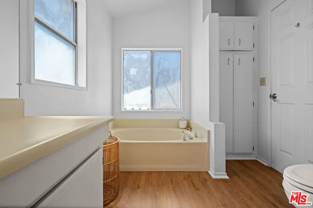a bathroom with a tub shower and sink