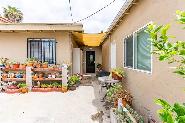 a front view of a house with outdoor seating