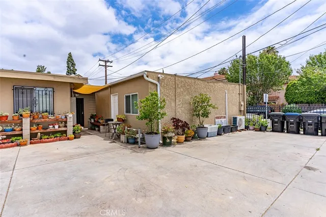 a view of a garage with a table and chairs under an umbrella
