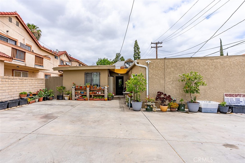 13809 Funston Avenue Norwalk, CA 90650 - Photo 9 of 16 a view of a patio with a table and chairs under an umbrella