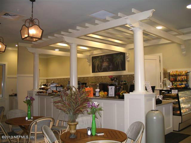 609 Racoon Court St. Johns, FL 32259 - Photo 29 of 32 a dining room with furniture wooden floor and a chandelier