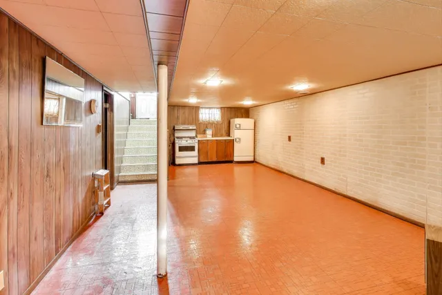 a kitchen with a stove top oven and a refrigerator