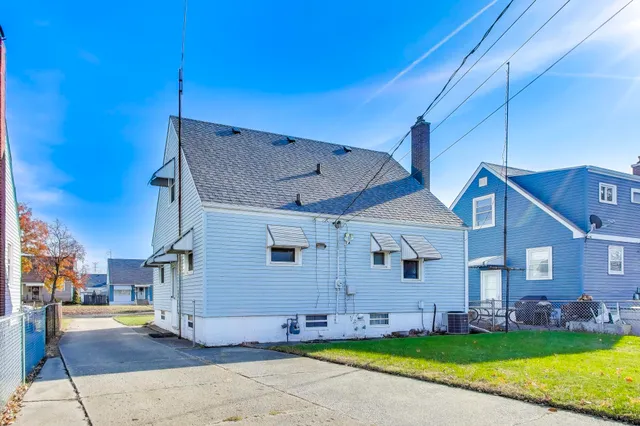 a view of a house with a backyard and a garage
