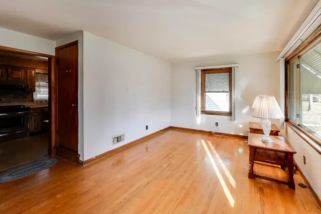 a view of a bedroom with furniture and wooden floor