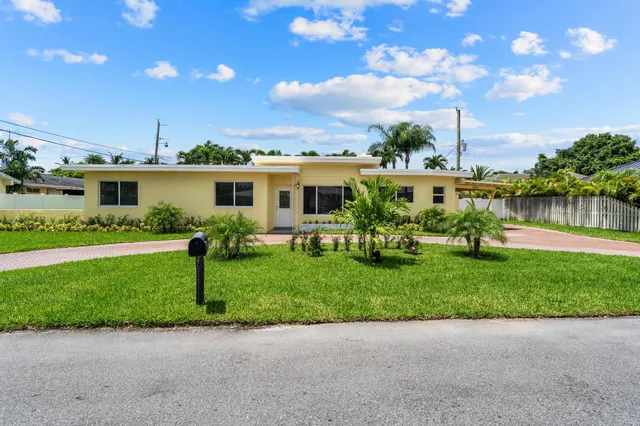 a view of a house with a backyard and a garden