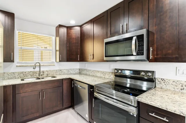 a kitchen with a sink stove and microwave