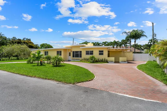 a view of a patio with a table and chairs