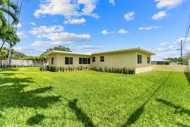 a view of an house with backyard space and garden