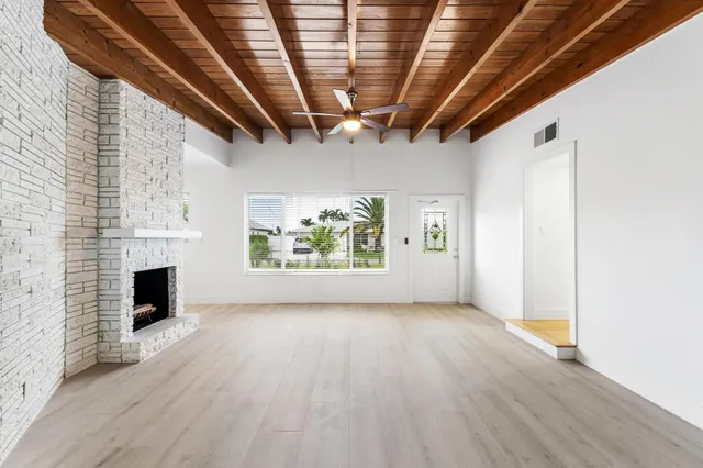 a view of livingroom with furniture wooden floor staircase and windows