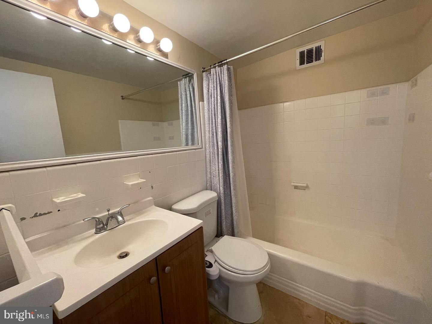 2101 Chestnut Street, Unit 1413 Philadelphia, PA 19103 - Photo 7 of 13 a bathroom with a sink and a mirror