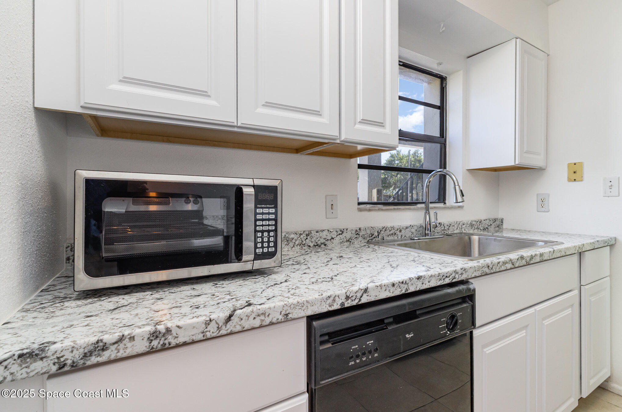 2249 Flower Tree Circle Melbourne, FL 32935 - Photo 8 of 16 a kitchen with granite countertop a sink stainless steel appliances and cabinets