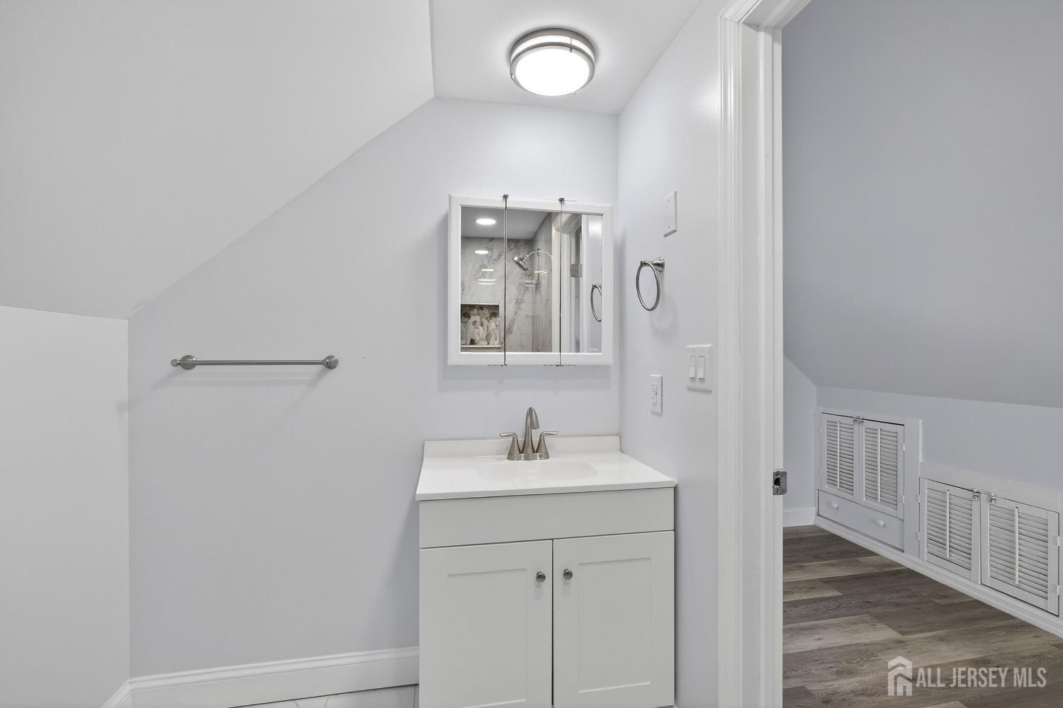 12 North Pennington Road New Brunswick, NJ 08901 - Photo 11 of 50 a bathroom with a sink a vanity and a mirror