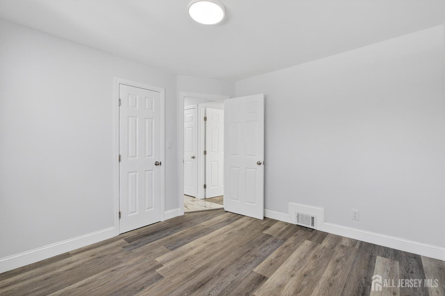 12 North Pennington Road New Brunswick, NJ 08901 - Photo 17 of 50 a view of an empty room and wooden floor