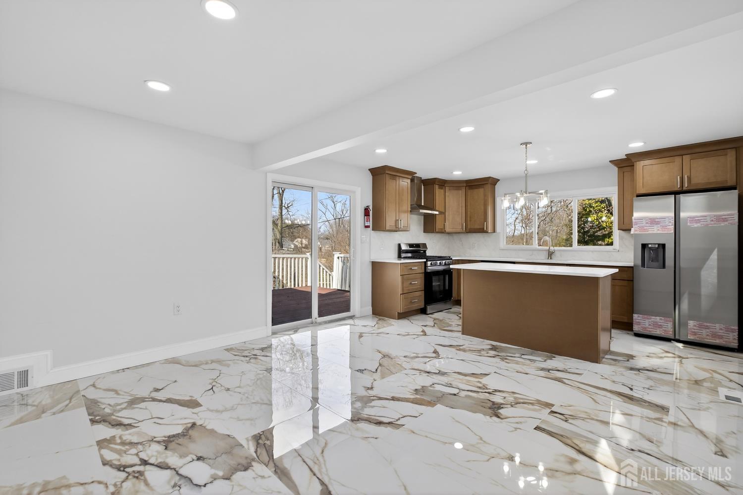 12 North Pennington Road New Brunswick, NJ 08901 - Photo 25 of 50 a kitchen with stainless steel appliances kitchen island granite countertop a refrigerator sink and cabinets