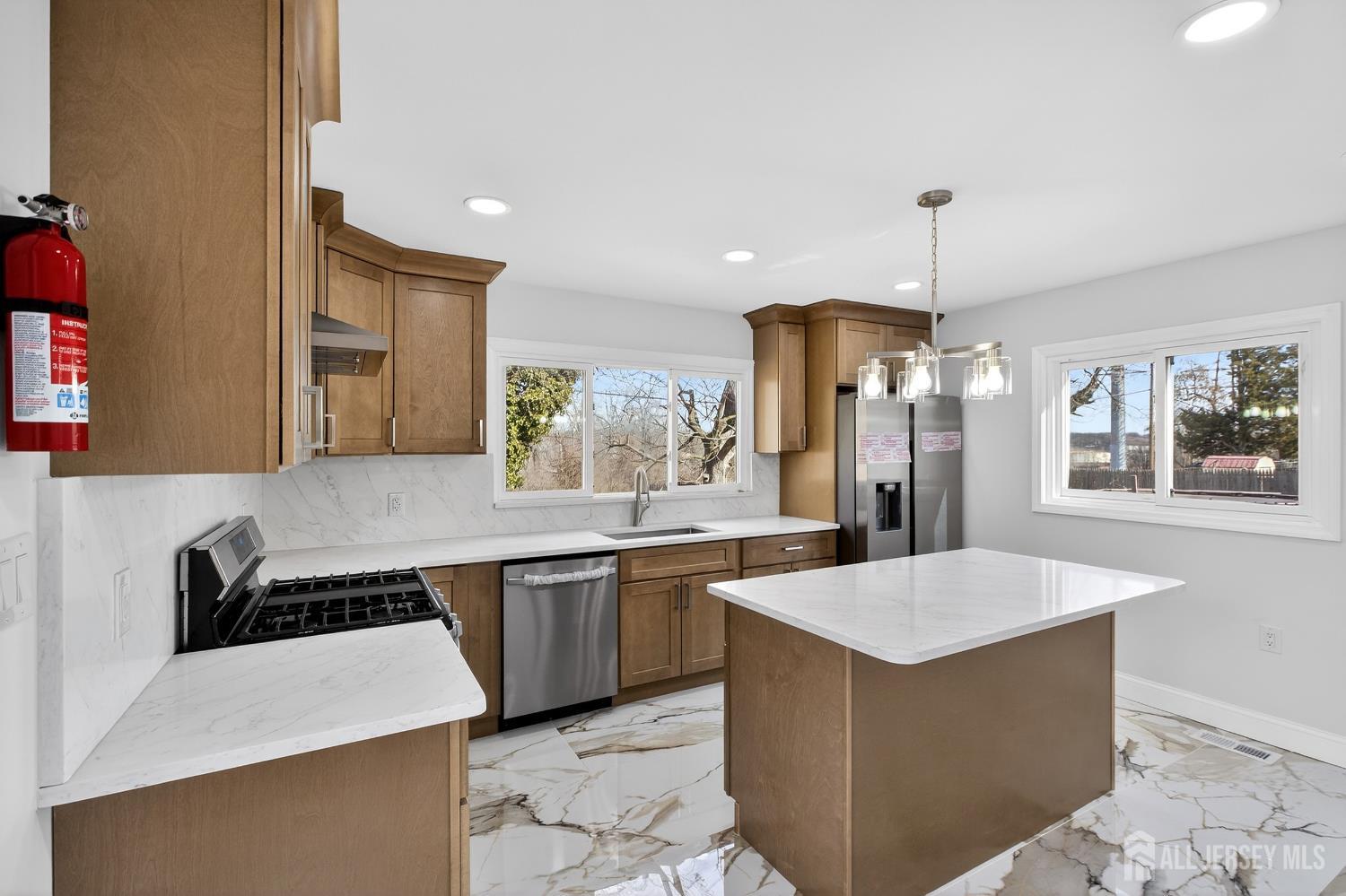 12 North Pennington Road New Brunswick, NJ 08901 - Photo 27 of 50 a large kitchen with kitchen island a sink stainless steel appliances and cabinets