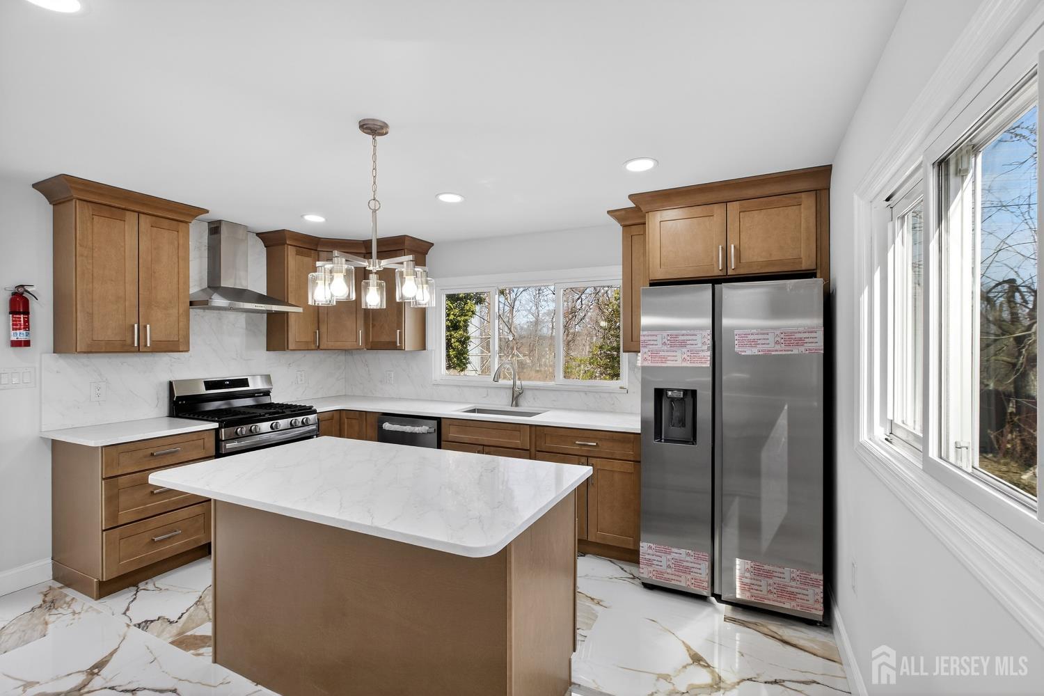 12 North Pennington Road New Brunswick, NJ 08901 - Photo 28 of 50 a kitchen with stainless steel appliances a sink stove and refrigerator