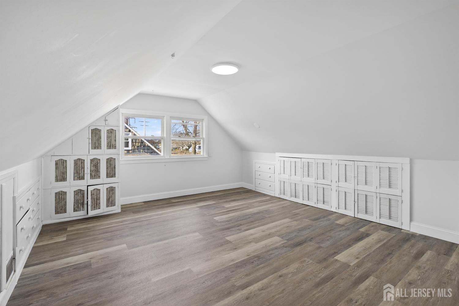 12 North Pennington Road New Brunswick, NJ 08901 - Photo 40 of 50 a view of an empty room with wooden floor and a window