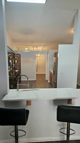 a hallway with a table and chairs