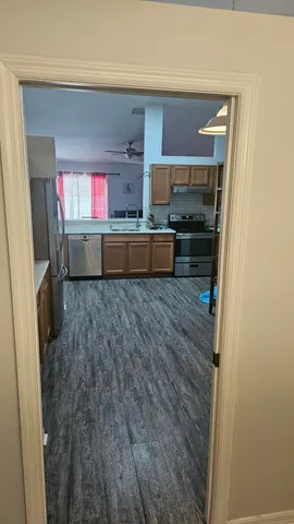 a kitchen with granite countertop a refrigerator and a sink