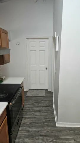 a view of a kitchen from the hallway