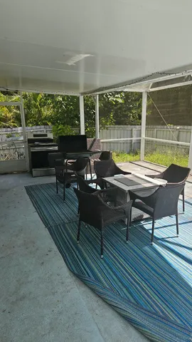 a swimming pool view with a seating space