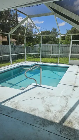 a view of a backyard with a swimming pool