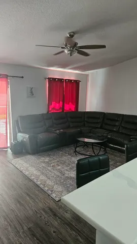 a kitchen with stainless steel appliances a stove a window and red cabinets