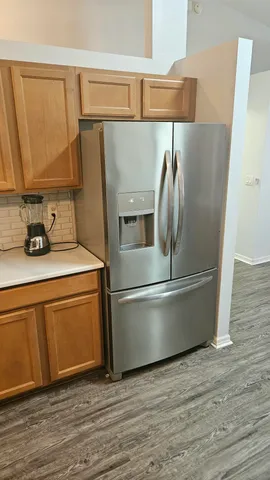 a kitchen with stainless steel appliances a refrigerator and a sink